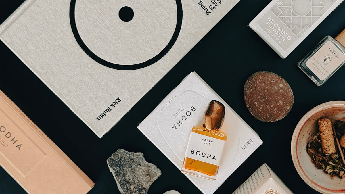 Collection of Bodha products including boxes, packaging, and a bowl on a dark surface.